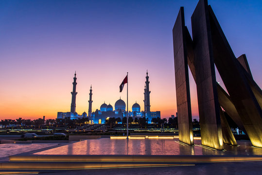 Grand Mosque in Abu Dhabi and Wahat al Karama monument after sunset