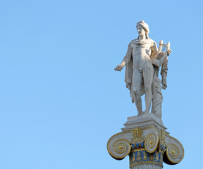 Fototapeta na wymiar Apollo statue with his face illuminated by sun rays on blue sky background, space for text