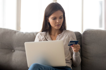 Girl hold credit card shopping at laptop online