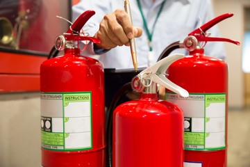 Engineer are inspection Fire extinguisher in fire control room for prevention, rescue and safety...