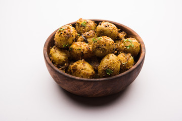 Jeera Aloo - Potatoes Flavoured With Cumin seeds and spices. popular Indian main course recipe. served in a bowl. selective focus
