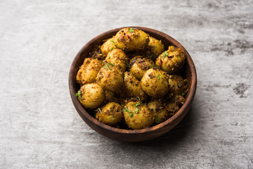 Jeera Aloo - Potatoes Flavoured With Cumin seeds and spices. popular Indian main course recipe. served in a bowl. selective focus