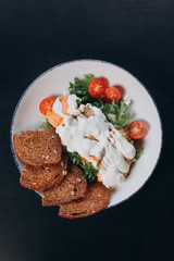 salad with cherry tomatoes, white sauce and crackers