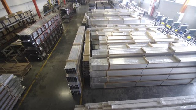 Close up shot of aluminium profiles. Aluminium production line factory warehouse stack of profiles. Heavy metallurgical industrial products, manufacturing business production concept