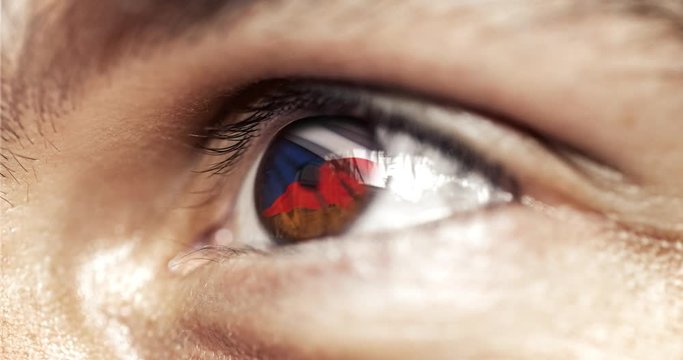 Man with brown eyes in close up, the flag of Czeck republic in iris,  with wind motion. video concept