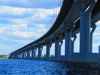 Bridges over a frozen river. Bridge piers. Bridge interchange on sky background. Modern road junction over the river. Concept - building bridges. Road architecture.