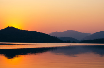 Fototapeta na wymiar sunset sunrise over river and mountain