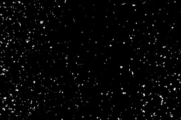 White snow falling down on black background