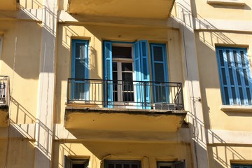 balcony and blue wood blinds in an old building in Beirut