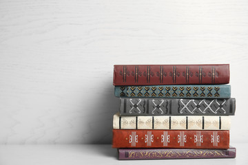 Collection of different books on table against white wooden background. Space for text