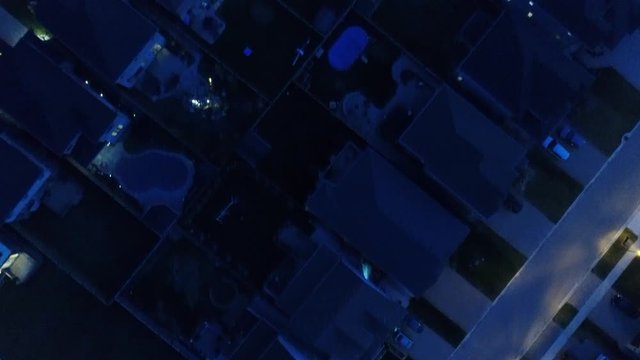 Diagonal Top Down View Of House Rooftops At Night Drone Aerial