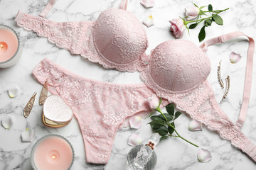 Flat lay composition with women's underwear on marble background - obrazy, fototapety, plakaty