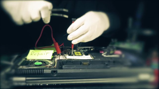 Engineer using screwdriver to fix or upgrade laptop computer. Computer Service.
