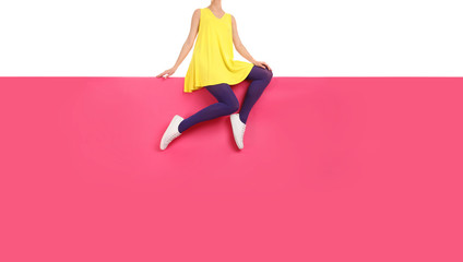Woman wearing purple tights and stylish shoes sitting on color background, closeup