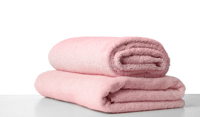 Obraz na płótnie Canvas Folded fresh clean towels for bathroom on table against white background. Space for text