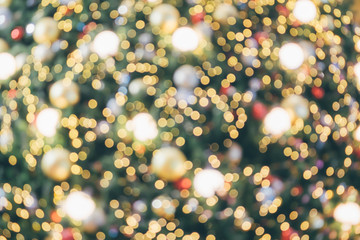 Abstract christmas holiday with festive gold bokeh light on tree blurred background