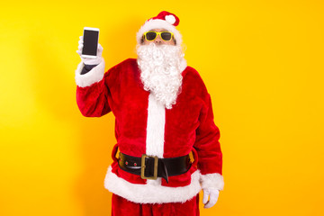 Fototapeta na wymiar santa claus with mobile phone in hand