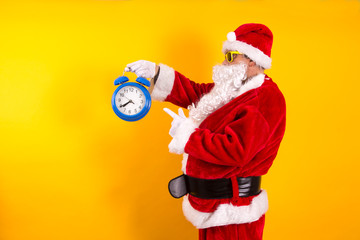 Santa Claus pointing the alarm clock, Christmas is coming