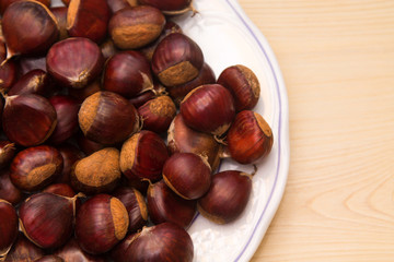 plate of chestnuts on wood