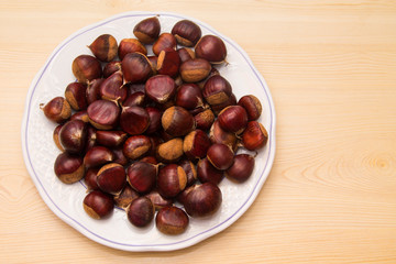 plate of chestnuts on wood