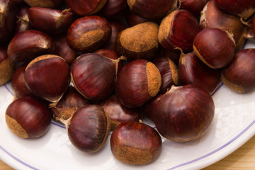 plate of chestnuts on wood