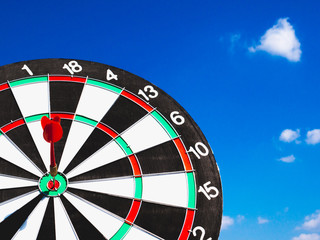 Dart Board Isolated on blue sky and clouds background, Setting challenging business goals And ready...