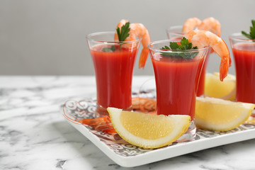 Shrimp cocktail with tomato sauce served on marble table
