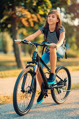 Fototapeta na wymiar School girl riding bicycle