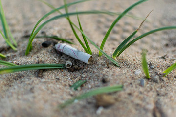 Cigarette butt polluting earth