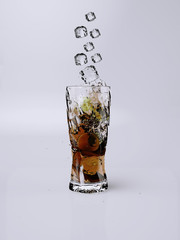 Glass of lemon tea  with splashing when iced cubes dropping down to the cup. Lemon tea with with iced cubes.