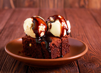 Brownie cake with ice cream and chocolate sauce