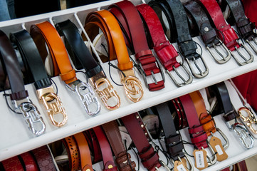 China, Heihe, July 2019: Showcase with leather straps in Huafu shopping center