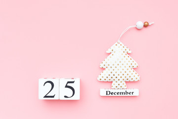 Wooden calendar December 25, textile christmas tree on pink background. Merry christmas concept. Top view Flat lay Template for design, greeting card, postcard