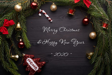 New Year's card. Black wooden background with text "Merry Christmas Happy New Year 2020"