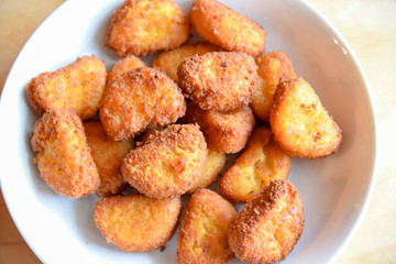 Chichen Nuggets in the Plate on Wooden Table
