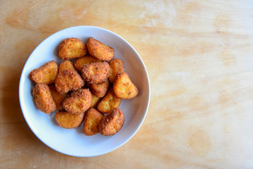 Chichen Nuggets in the Plate on Wooden Table