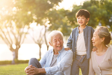 asian grandparents enjoying good time with grandson
