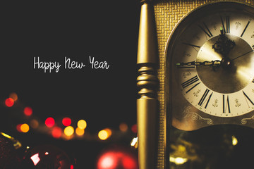 Retro style clock counting last moment before to Happy New Year at midnight time on bokeh blurred...