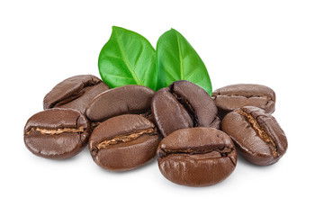 Heap of roasted coffee beans with leaves isolated on white background.