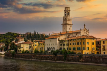 Plakat View of the historic city center along Adige river at sunset in Verona, Italy.