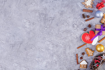 Christmas background. Christmas gift, toys, gingerbread cookies, spices and decorations on wooden background. Top view