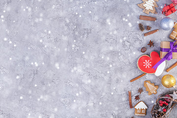 Christmas background. Christmas gift, toys, gingerbread cookies, spices and decorations on wooden background. Top view