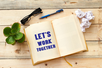 note showing Let'S Work Together, on open notebook