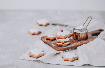 Homemade Christmas star shape gingerbread cookies with frosting.