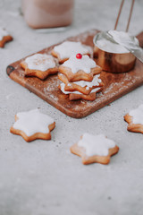 Homemade Christmas star shape gingerbread cookies with frosting.