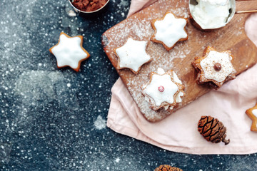 Homemade Christmas star shape gingerbread cookies with cheese cream. Top view