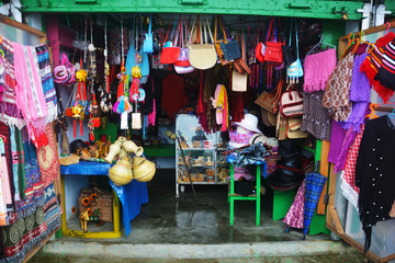 Close up of a shop displaying varieties of handicraft local goods like bags, shawls in Elephant...