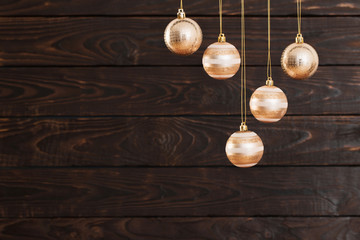 Christmas balls hanging  on  dark  wooden background