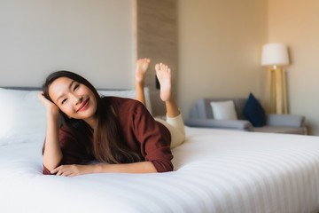 Portrait beautiful young asian women happy smile relax on bed