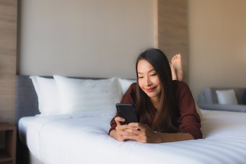 Obraz premium Portrait beautiful young asian women using mobile phone on bed